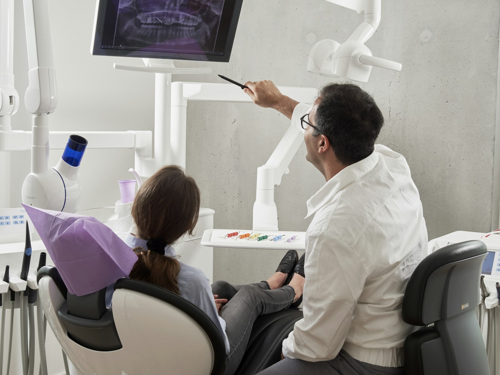 Dentist reviewing dental X-rays with a patient
